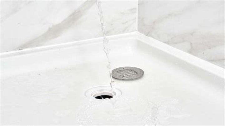 What happens if there is a blockage in the shower drain?